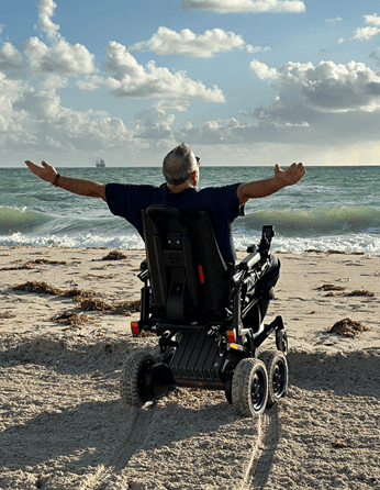 Nick on beach, hands up