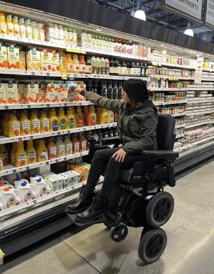 iBOT user shopping for groceries, reaching to shelf in Balance Mode